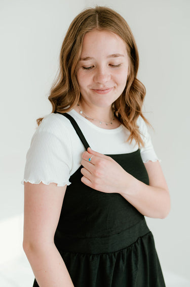 black inch wide strap jumper with ankle length and form fitting bodice.