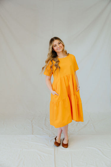 This dress features a tiered skirt, flowy sleeves, and pockets!