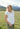 Relaxed Hampton Top with embroidery, worn outdoors in a scenic mountain setting, showcasing casual elegance.