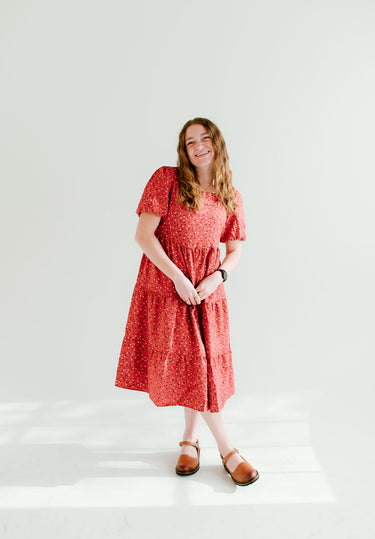 Modest red floral dress with short sleeves and pockets.