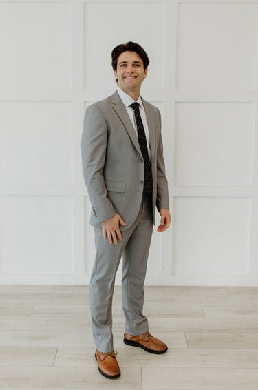 Man wear grey suit with black tie