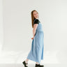  blue inch wide strap jumper with ankle length and form fitting bodice.