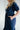 navy dress with square neckline, puff sleeves, pockets, embroidered flowers and a fitted bodice