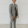 Man wear grey suit with black tie